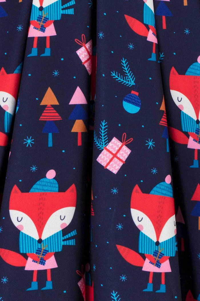 Navy blue dress with all over cartoon fox print with wrapped gifts, colourful Christmas trees, baubles and stars in the background.