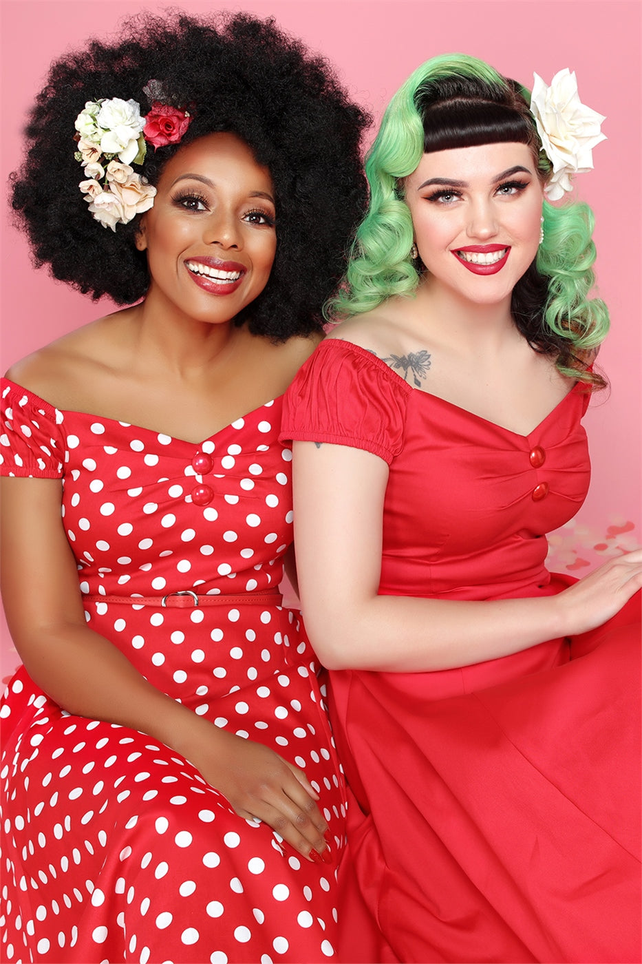 Pin up 40s and 50s models wearing red lipstick, hair flowers and dolores dresses