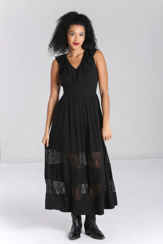 Tall, slim woman wearing red lipstick standing in a black lace maxi dress and black boots