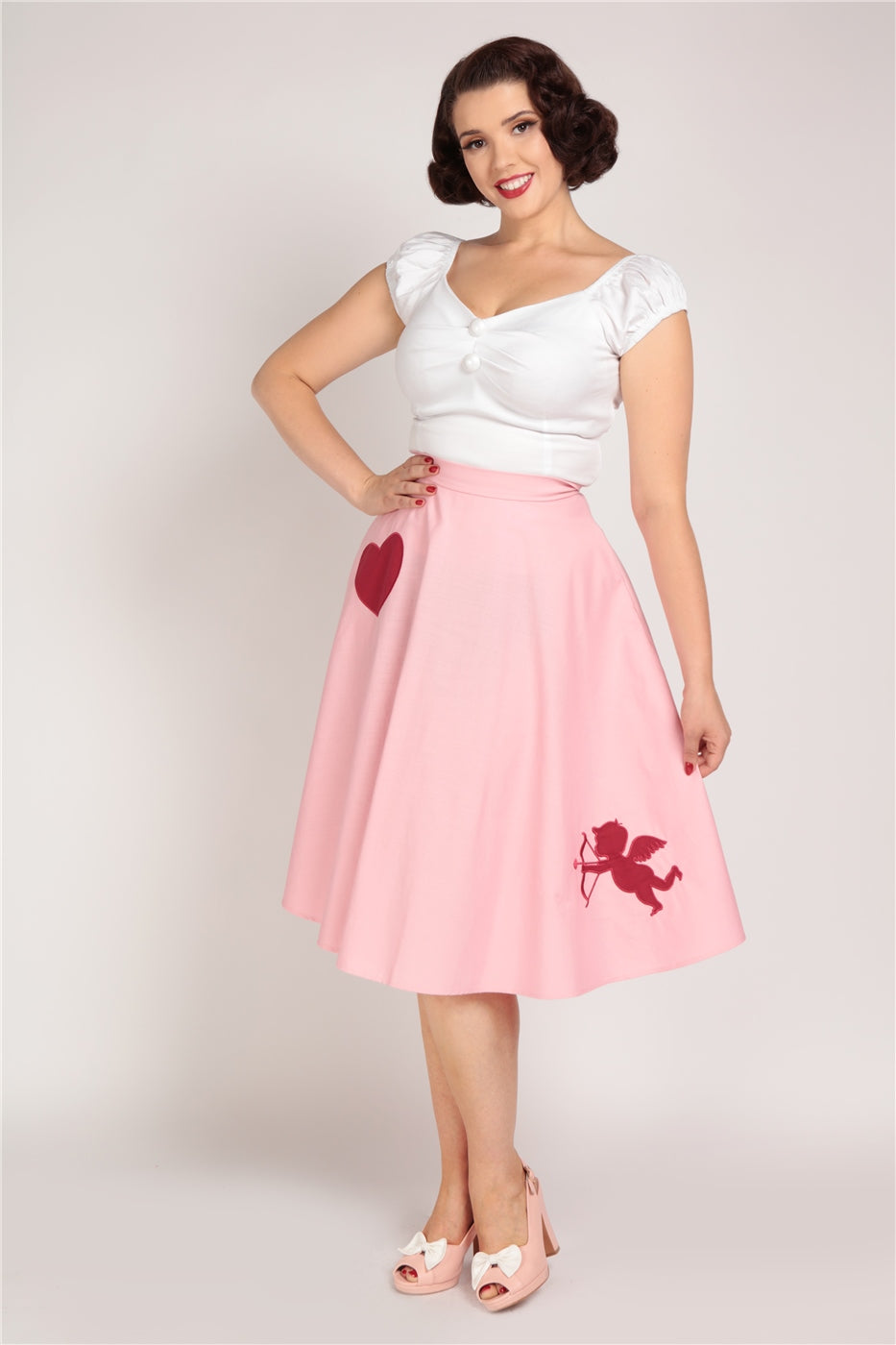 Happy, smiling lady wearing the white Dolores top and the Cupid Swing Skirt by Collectif