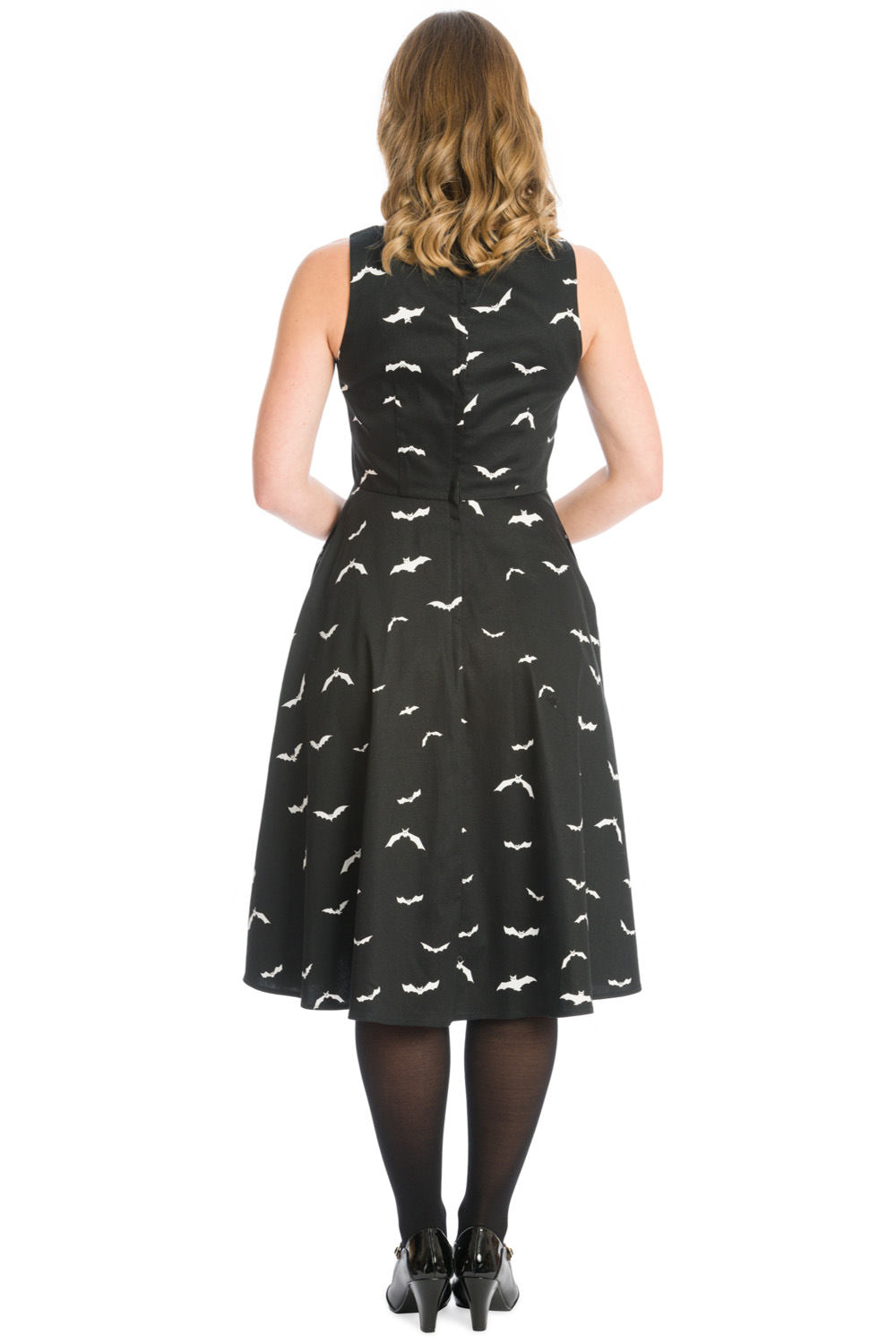 Rear view of a blonde model showcasing a black swing dress with an all-over white bat print