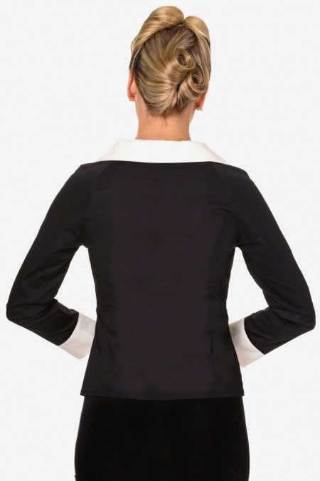 Back view of a cheerful blonde model with her hair elegantly up, highlighting the Beautiful People Shirt in Black and White by Banned.