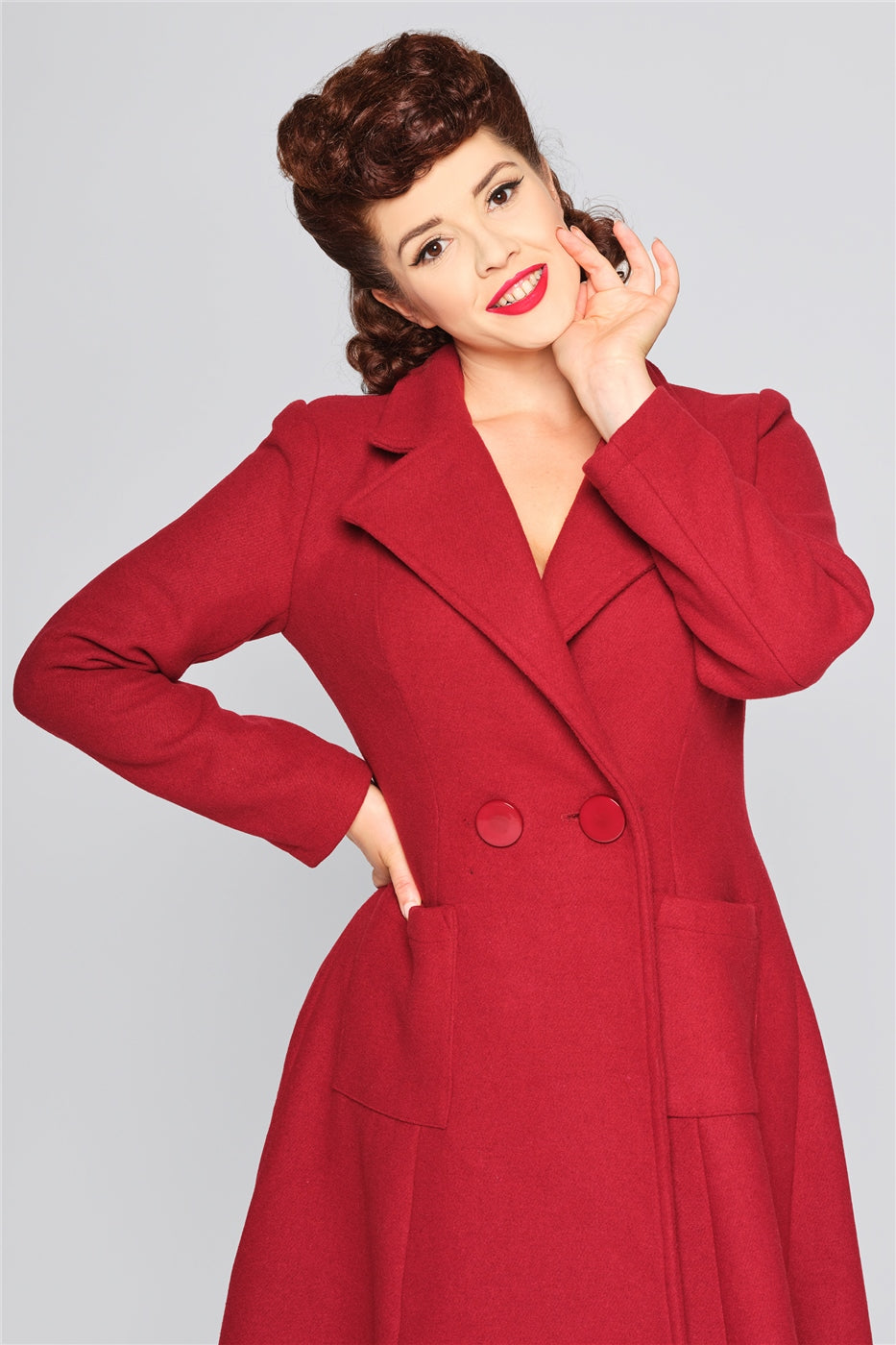 beautiful brunette wearing red lipstick and a burgundy coat with a classic vintage collar and two buttons at the front