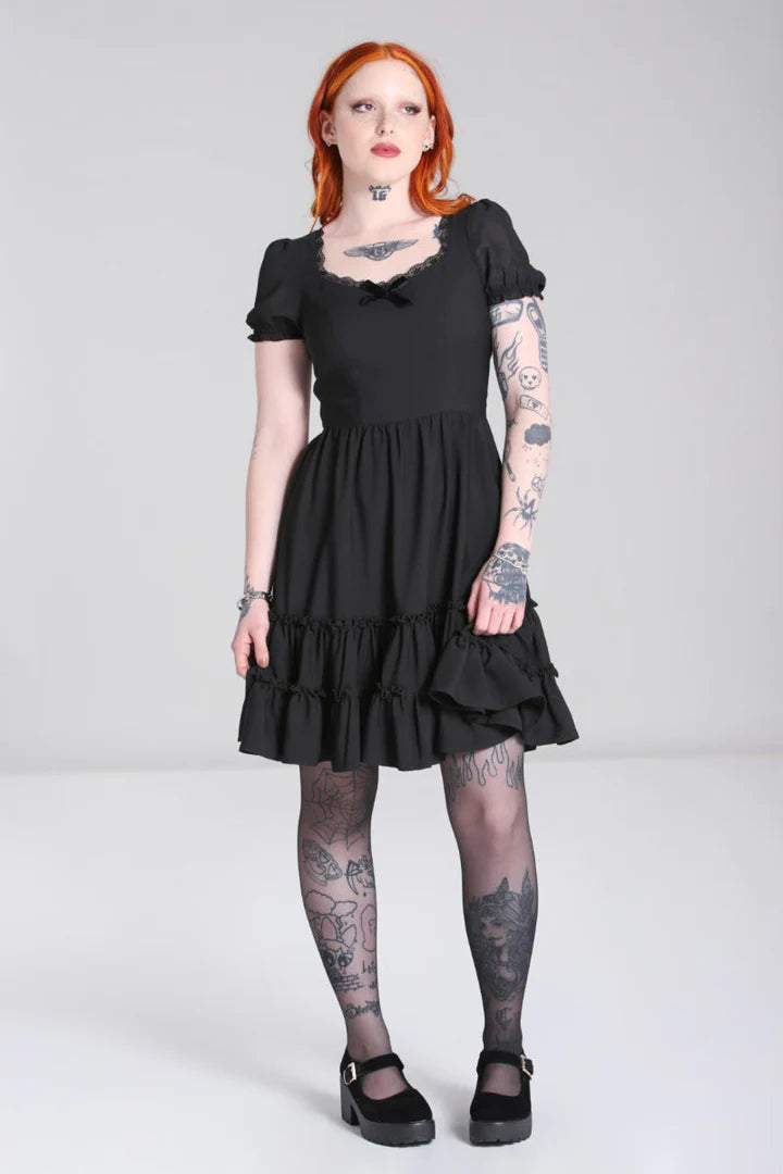 Tattooed girl with bright orange hair wearing the Annette black dress by Hell Bunny