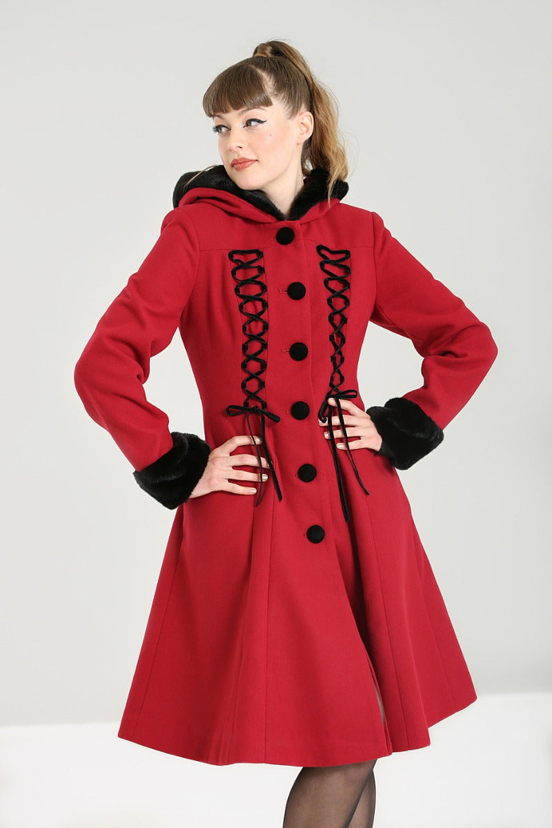 Pretty brunette woman wearing a burgundy swing coat with black laceup front detail and buttons