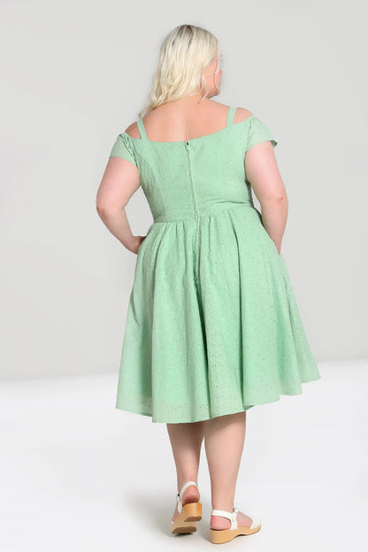 Back view of blonde model wearing the Celia dress and flat white sandals