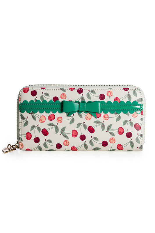 A white cherry print purse with a turquoise bow detail front and metal zip