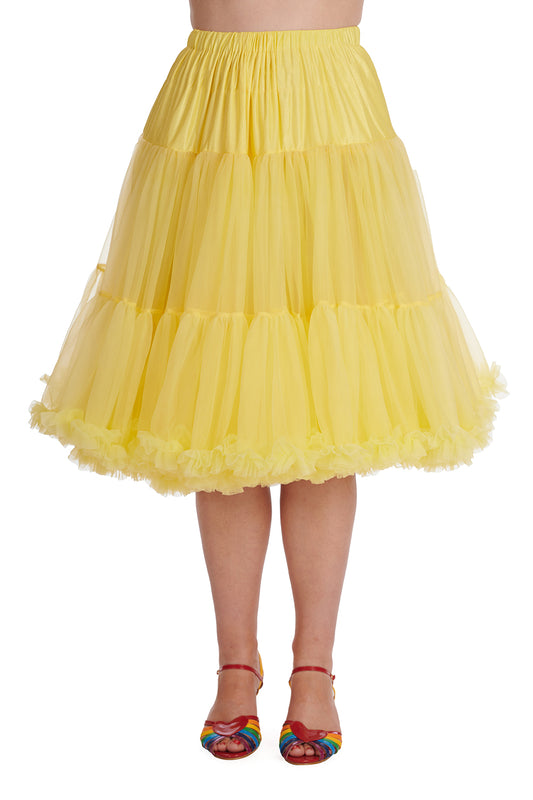 Woman wearing a bright yellow 26 inch full petticoat  and rainbow flat sandals