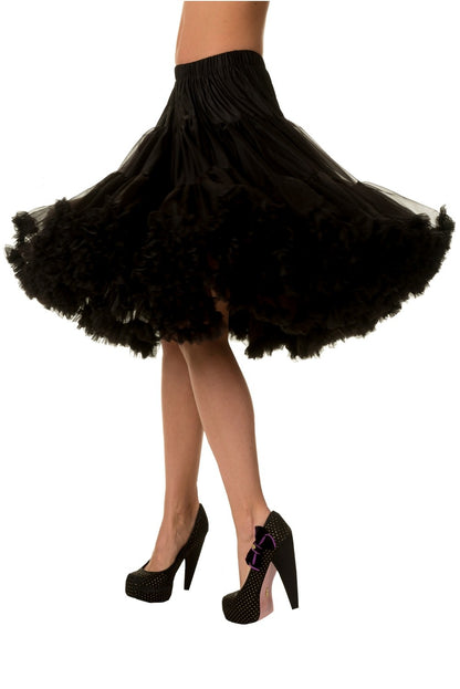 Model wearing black petticoat demonstrating how much it swishes by twirling