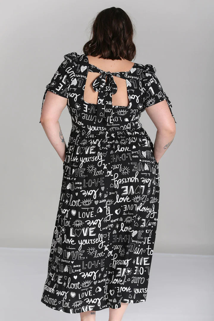 Brunette woman showing off the back of the Love Yourself Maxi Dress standing with her hands on her hips