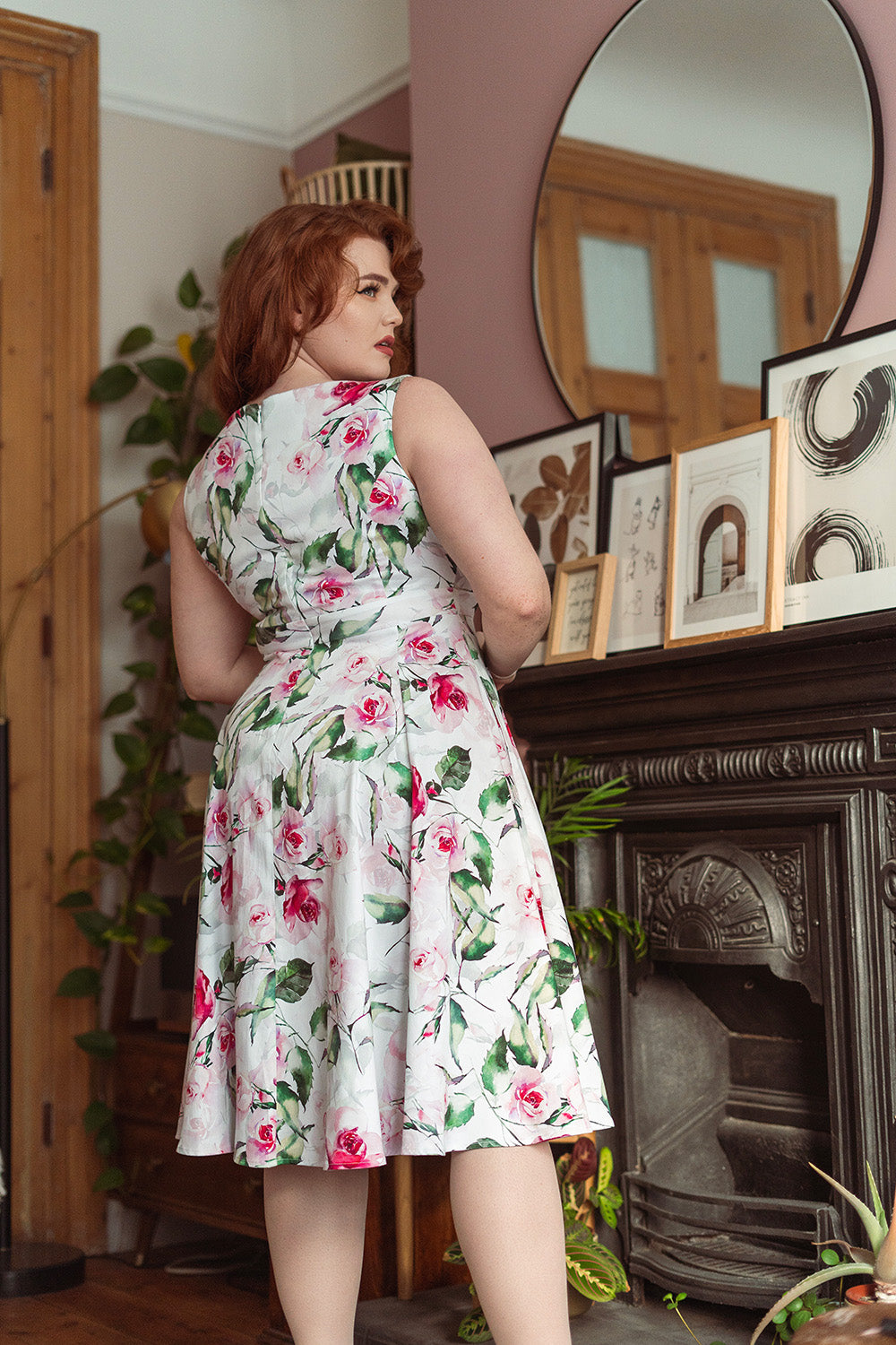 Curvy woman wearing a 50s fit and flare swing dress with a floral print