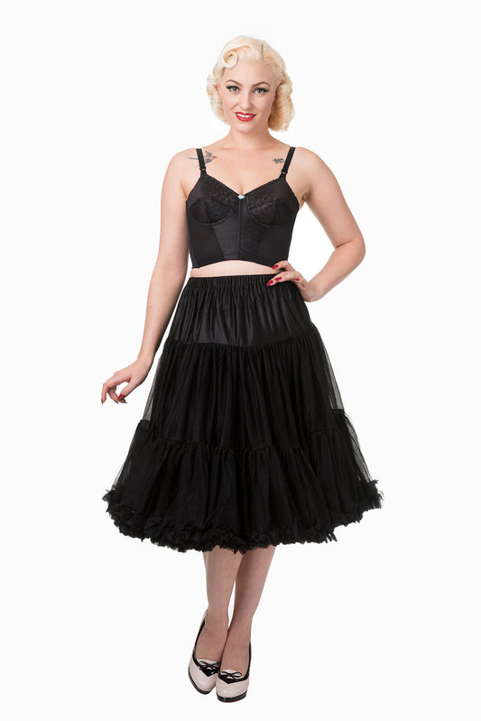 Blonde model wearing a classic 50s up-do hairstyle, bustier and black full 26 inch petticoat