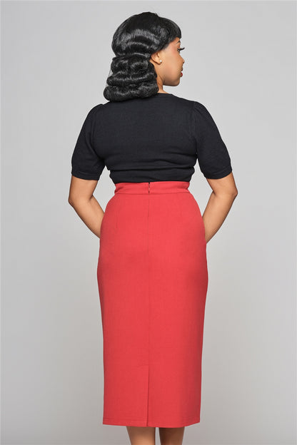 Dark haired woman standing straight, holding her hands in front of her wearing a black top and the Posey pencil skirt by Collectif