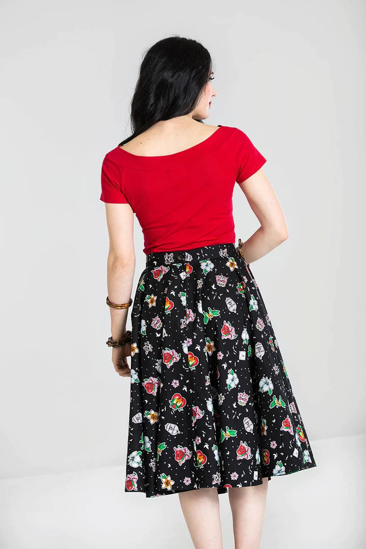 Glamorous woman with jet black hair standing facing away from the camera showing the back of the red Alex top.