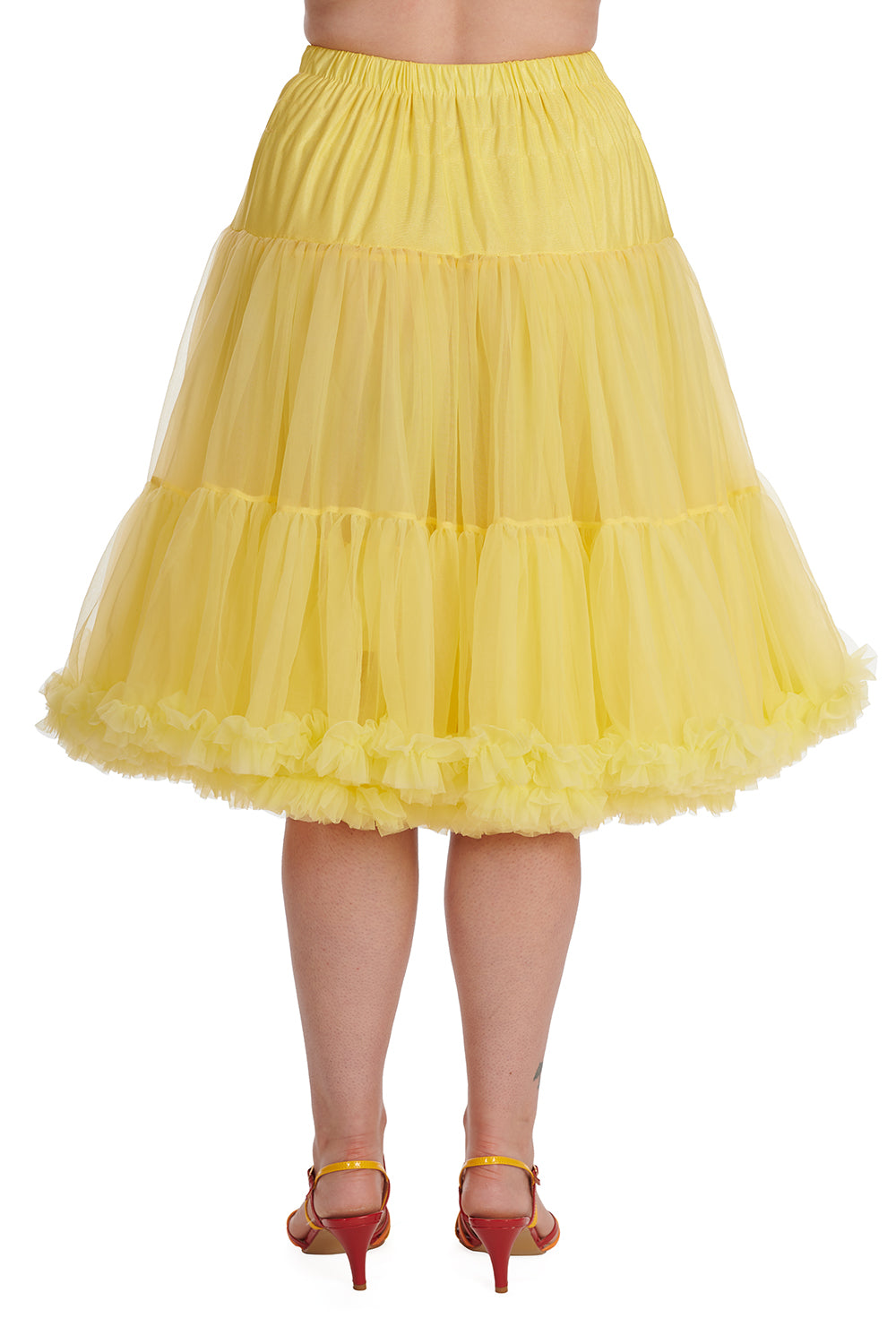 Back view of model wearing rainbow strappy sandals and a bright yellow Lifeforms Petticoat by Banned Retro