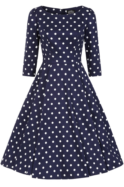 Navy blue dress with white polka dots on a white background