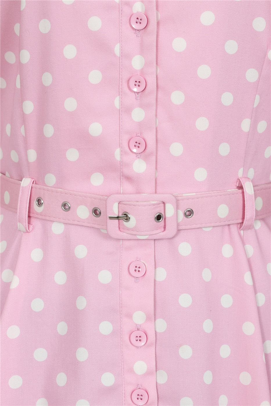 Close up of the pink polka dot Caterina dress front buttons and belt buckle.