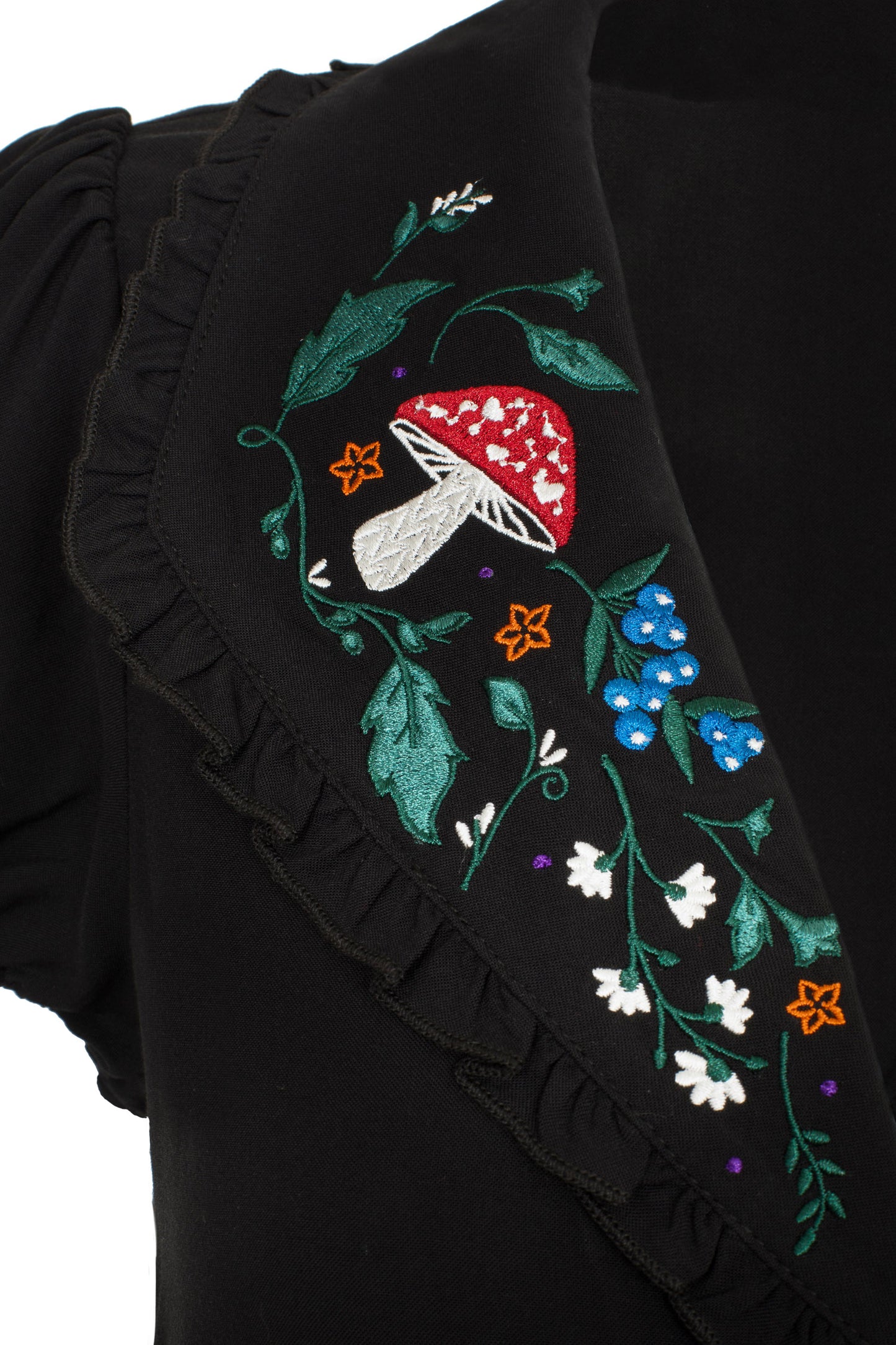 Close up of the embroidered mushroom, flowers and leaves on the Natura blouse collar