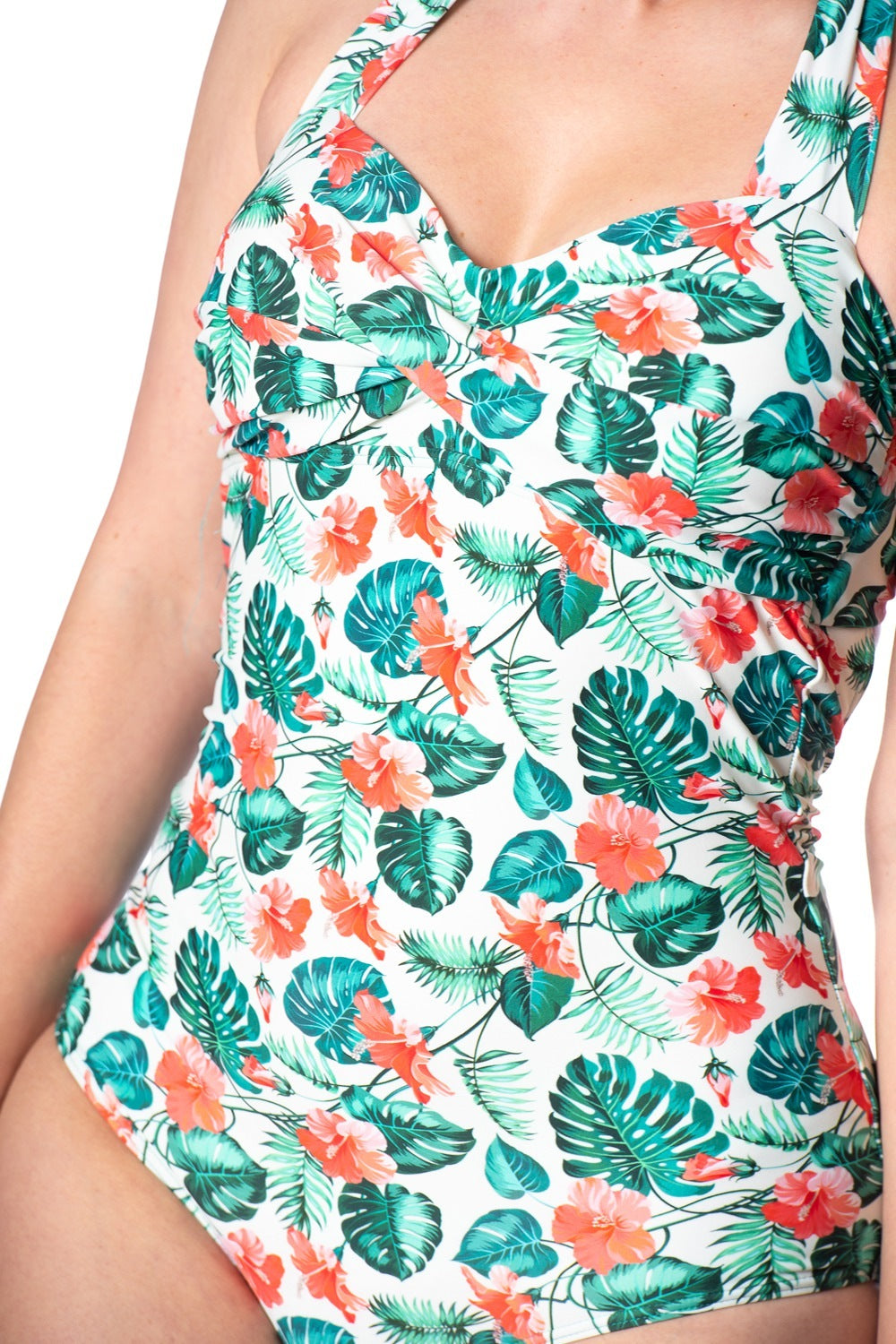 Retro vintage inspired swimsuit with tropical leaves and hibiscus flower pattern all over and ruching details at the bust