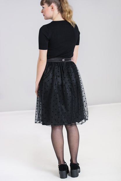 Blonde haired girl wearing a ponytail. The back of the black knee length skirt fastens with a button