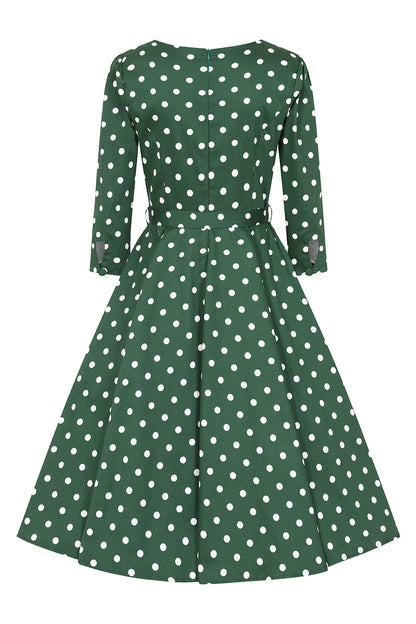 Green dress with white polka dots on a white background