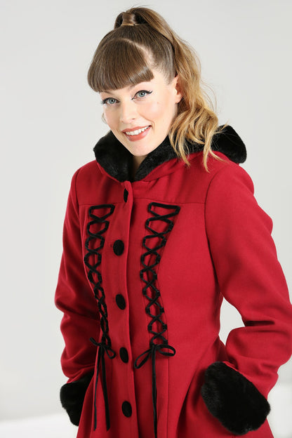 Smiling girl wearing a cosy red winter coat with faux fur hood and cuffs 