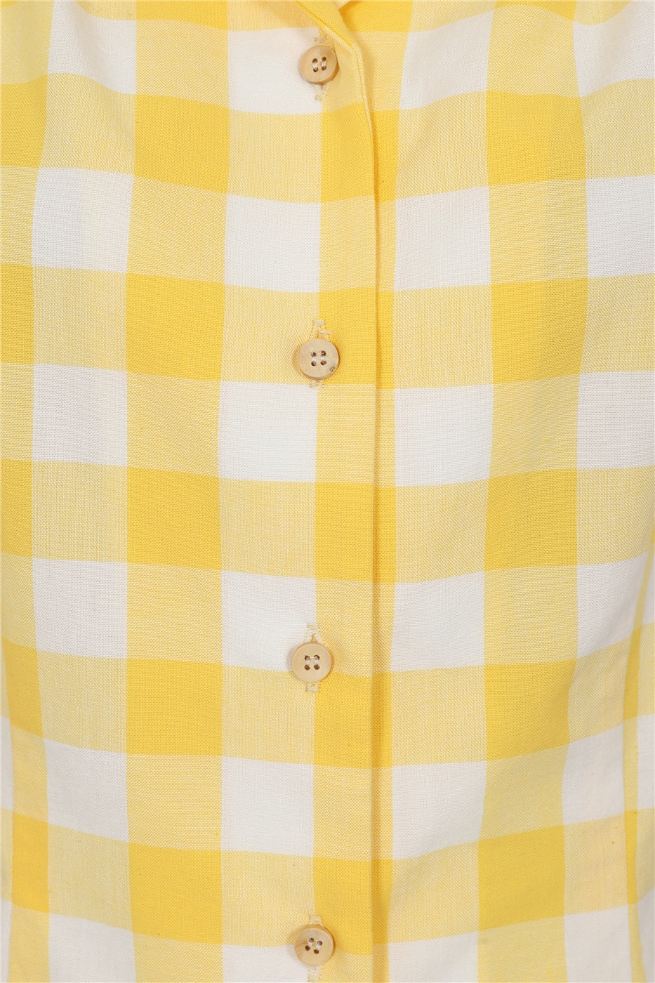 A close up look at the yellow coloured buttons at the front of the Luana blouse.