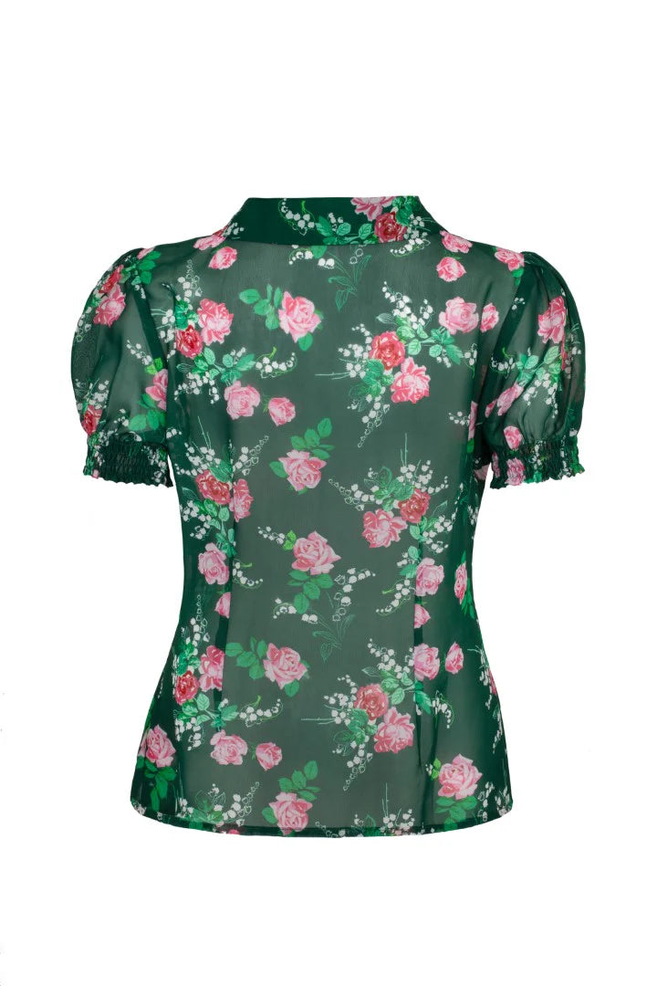 Green blouse with pink floral pattern on a white background