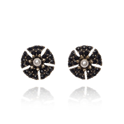 Pair of earrings with black and gold design on a white background