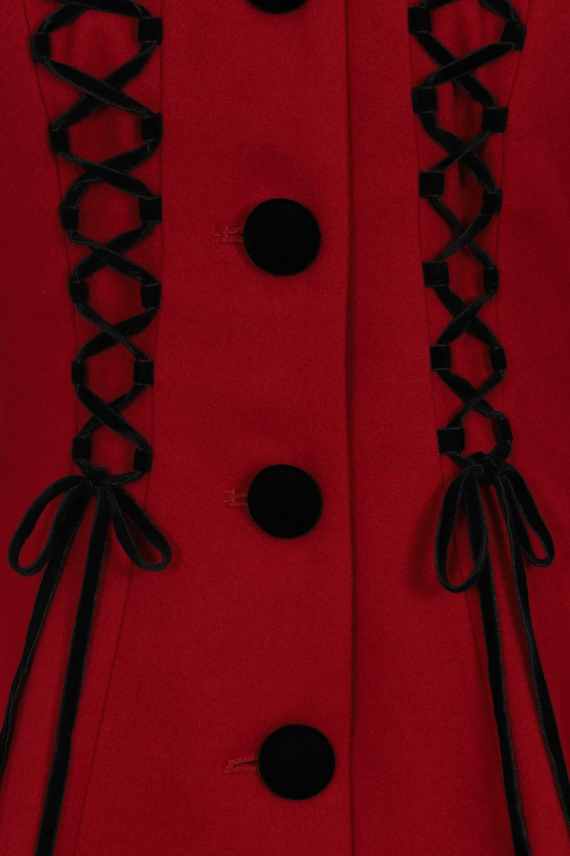 Closeup of the velvet black laceup details and matching black buttons on the Amaya Red Coat