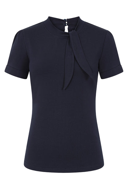 Navy blue top against a plain white background. The top has short sleeves and a tie neck with a two button fasten at the back of the neck.