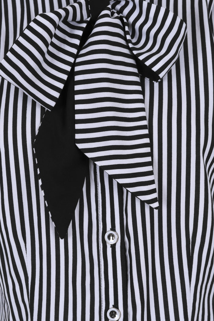 Close up of the black and white striped Humbug blouse's pussybow tie neck and the small white buttons on the front. 