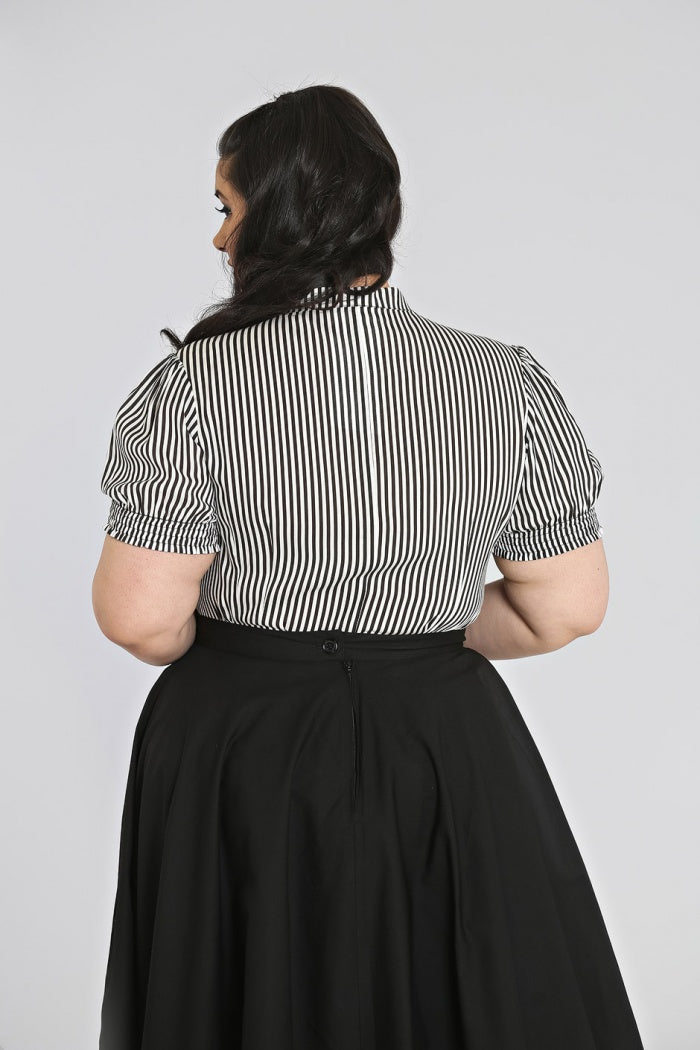 Back view of black and white Humbug blouse by Hell Bunny worn with a black skirt. 