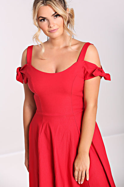 Blonde haired woman with brown eyes wearing a red 50s style dress