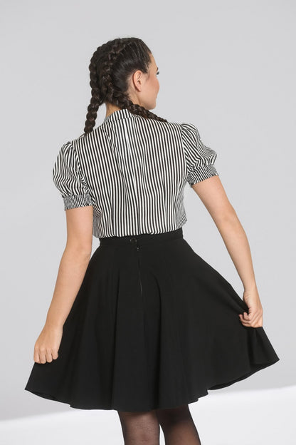 Woman with her hair plaited wearing a black mini skirt and the black and white striped Humbug blouse by Hell Bunny.