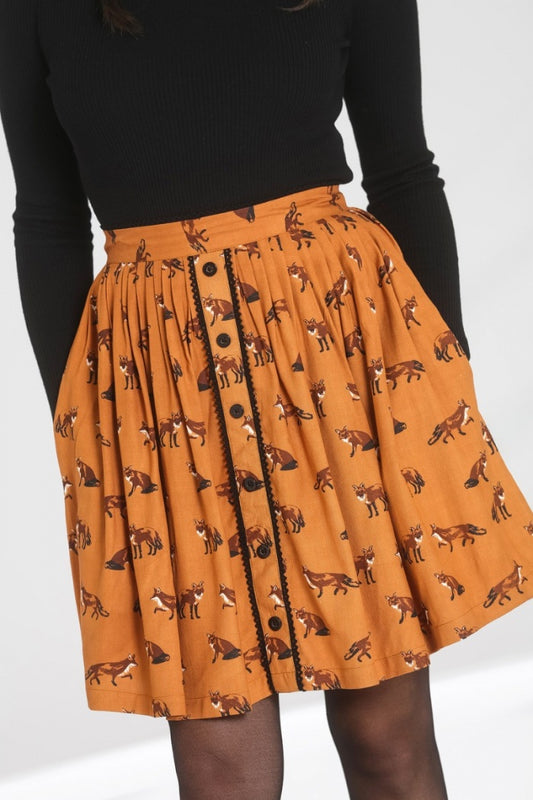 Close up of a girl wearing a brown/mustard colour mini skirt with a realistic fox print all over and decorative black buttons down the front