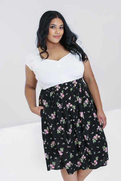 Smiling brunette plus size model with one hand in her pocket 