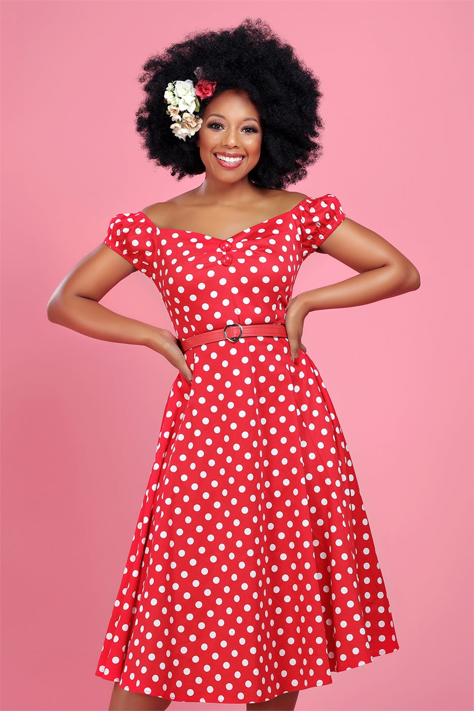 happy smiling girl wearing hair flowers in her hair and a red and white 50s style dress