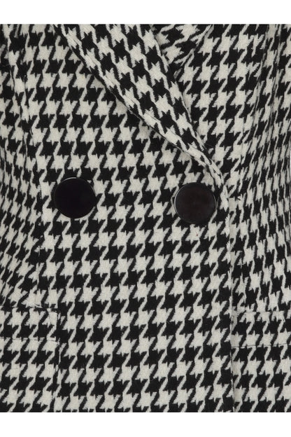 Close up of the two black front buttons on the dogtooth coat