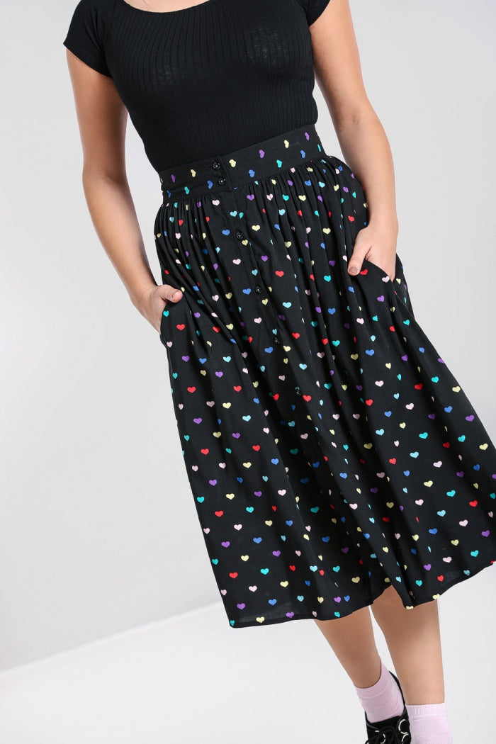 Button front skirt with multicolour heart print on a black background with pockets