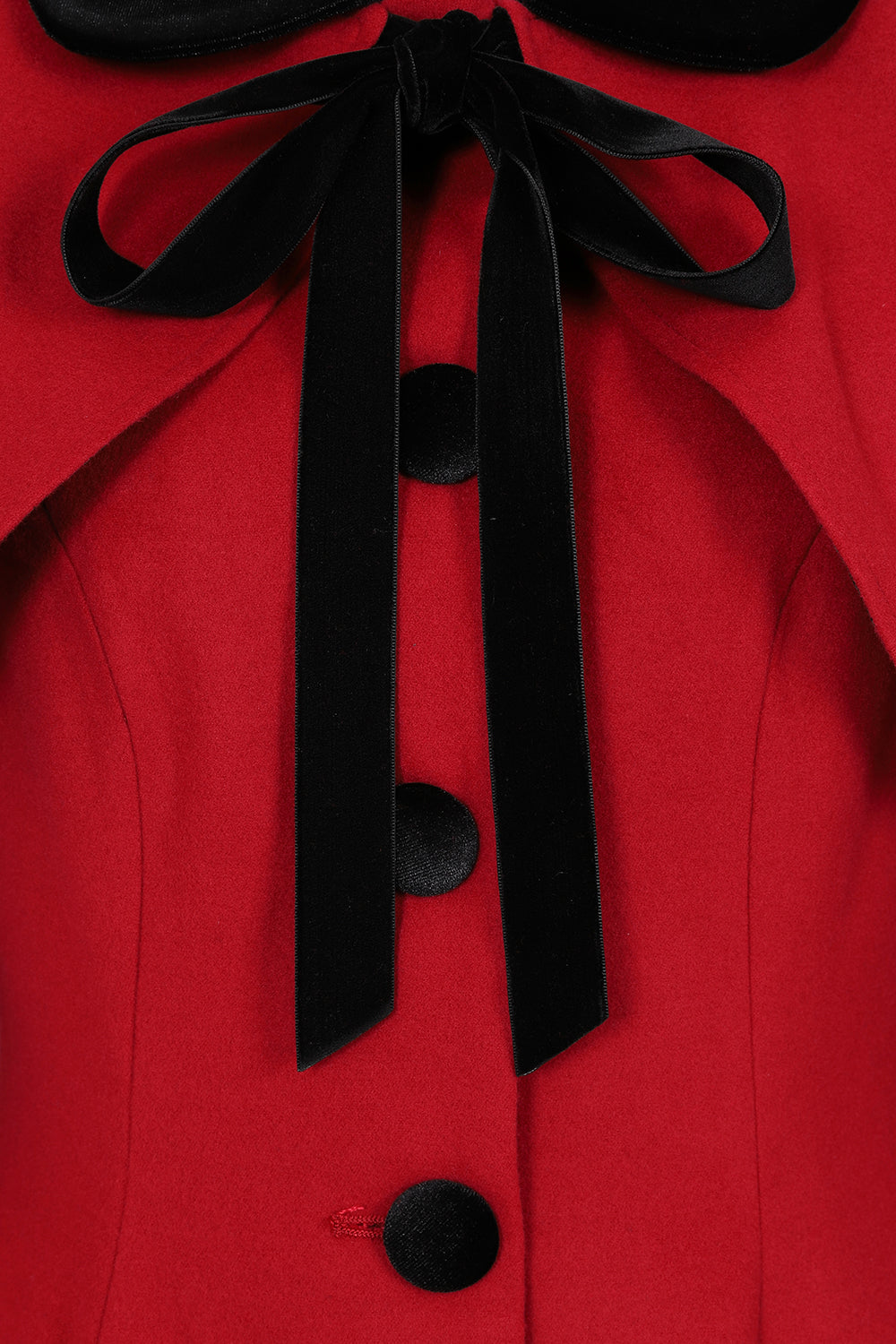 Close up of red Anouk coat where the cape ties at the neck with a black bow