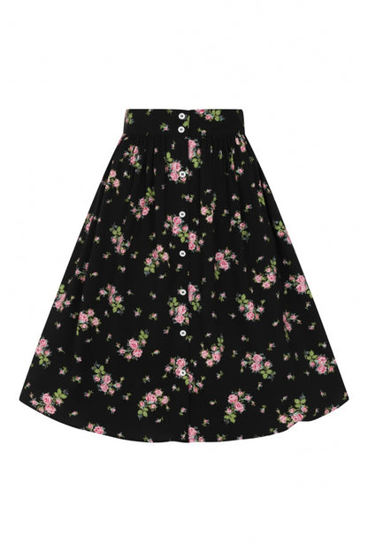 Flat lay of a black button-down floral print skirt against a white background