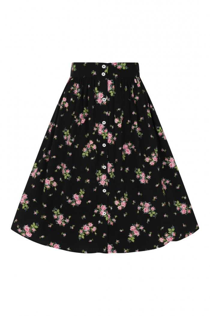 Flat lay of a black button-down floral print skirt against a white background