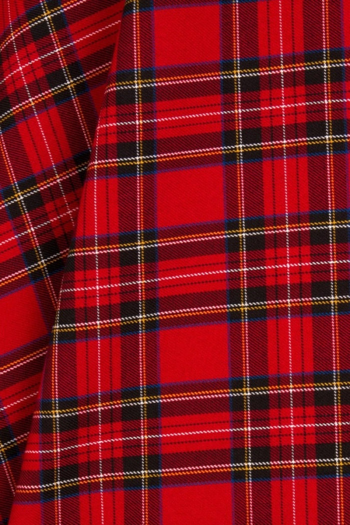 Closeup of the green, yellow, ivory and red tones in the skirt's checks