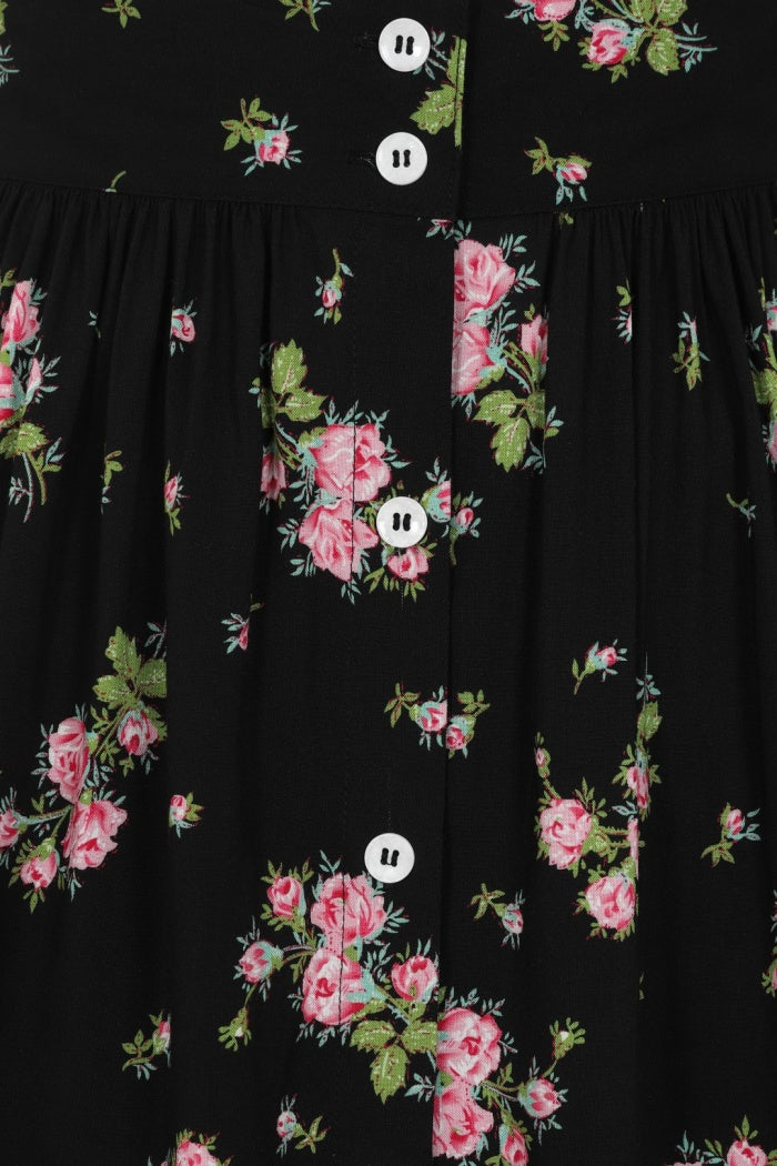 Close up of a black skirt with pink floral pattern