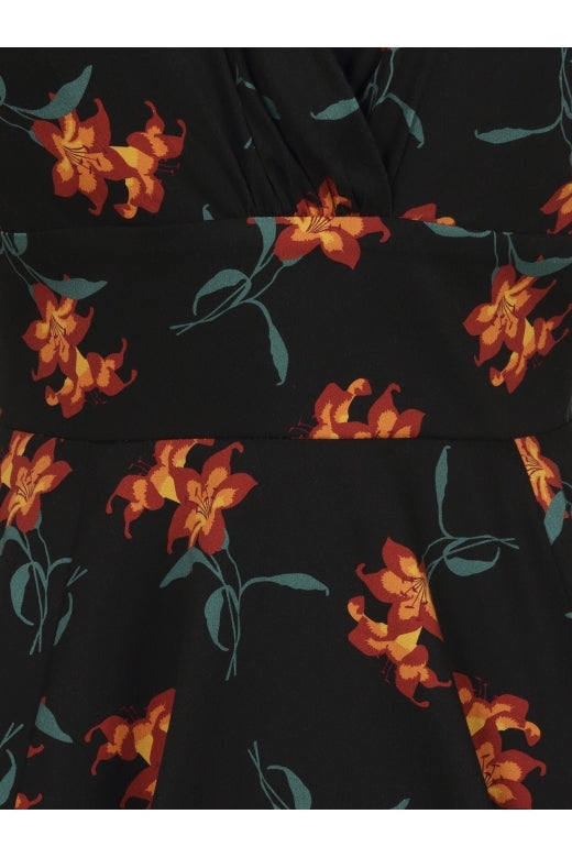 Close up of black dress fabric  with orange lily design