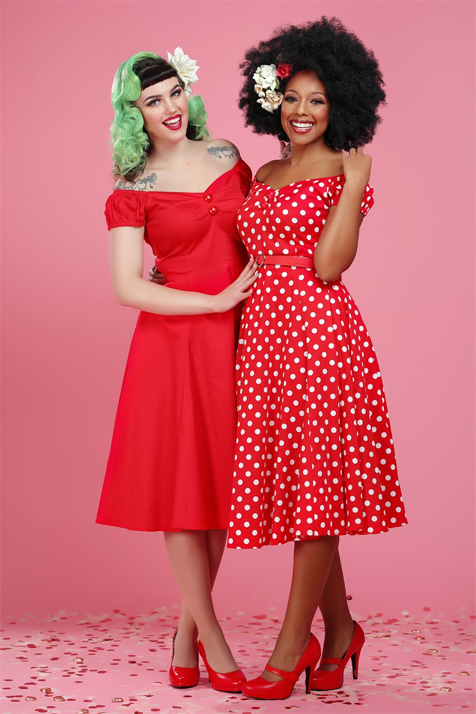 Vintage pin up style models wearing the dolores dress in red and red polka dot print and matching red heels
