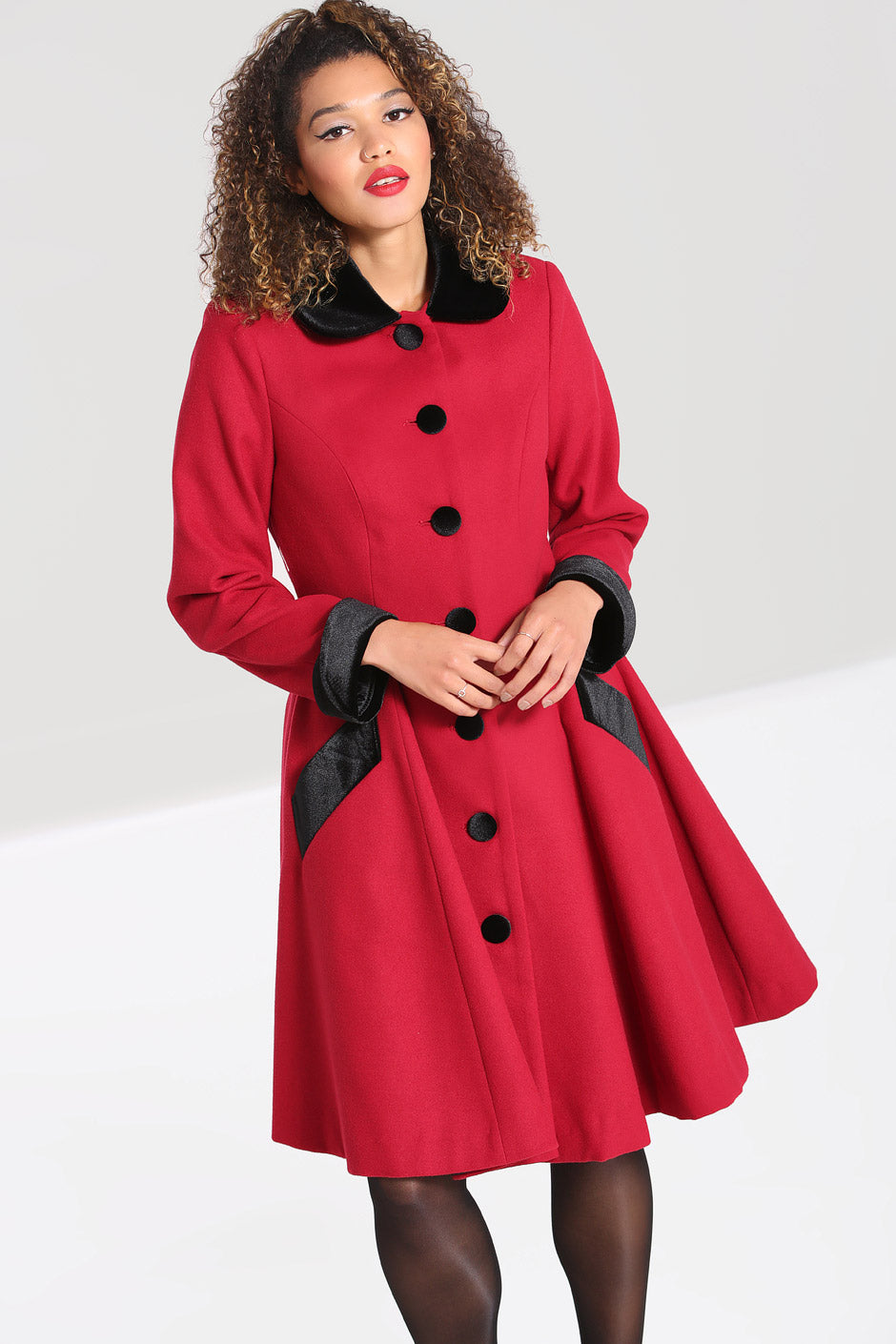 Glamorous woman wearing a vintage style red and black coat 